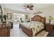 Cozy bedroom featuring a king-sized bed, a ceiling fan, and an attached sitting room with a large window at 315 Linger Ln, Sun City Center, FL 33573