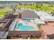 Aerial view of a community pool surrounded by patio seating with ample space for relaxation and socialization at 315 Linger Ln, Sun City Center, FL 33573