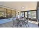 Sunroom featuring tile flooring, a table and chairs, and views of the backyard, perfect for relaxing or entertaining guests at 315 Linger Ln, Sun City Center, FL 33573