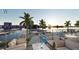 Inviting waterfront view from the balcony overlooking a pool, with chairs and tables to take in the scenery at 411 E Shore Dr # 206, Clearwater Beach, FL 33767