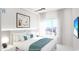 This modern main bedroom features a plush bed, a city view and TV at 411 E Shore Dr # 206, Clearwater Beach, FL 33767