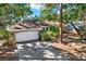 Front view of a brick house with a white garage door and landscaping at 4346 Marine Pkwy, New Port Richey, FL 34652