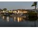 Waterfront view of community center and boat slips on canal at dusk at 4346 Marine Pkwy, New Port Richey, FL 34652