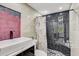 Modern bathroom with marble vanity, walk-in shower, and patterned shower curtain at 4408 W Minnehaha St, Tampa, FL 33614