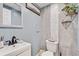 Clean and updated half bathroom with gray tile and decorative shelving at 4408 W Minnehaha St, Tampa, FL 33614