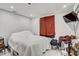 Bright bedroom with a white comforter and red curtains at 4408 W Minnehaha St, Tampa, FL 33614