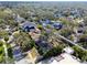 Aerial view of the property surrounded by mature trees and landscaping in a serene neighborhood at 4532 W Beachway Dr, Tampa, FL 33609