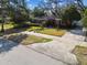 Charming single-story home featuring mature landscaping, a brick facade, and a driveway at 4532 W Beachway Dr, Tampa, FL 33609