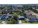 An aerial view showcases the house, fenced backyard, mature trees, and neighborhood surroundings at 4570 69Th N Ave, Pinellas Park, FL 33781