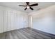 Spacious bedroom with wood-look flooring, neutral walls, closet, and ceiling fan at 4570 69Th N Ave, Pinellas Park, FL 33781