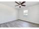 A bright and airy empty bedroom with modern ceiling fan and wood-look flooring at 4570 69Th N Ave, Pinellas Park, FL 33781