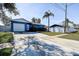 Inviting single-story home with a blue exterior, attached garage, and a well-manicured front yard at 4570 69Th N Ave, Pinellas Park, FL 33781