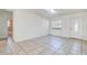 Bright living room with tile floors, a skylight, and a view of the front door and an adjacent room at 4570 69Th N Ave, Pinellas Park, FL 33781