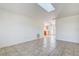 Bright living room with tile floors, a skylight, and a view of the adjacent dining room and kitchen at 4570 69Th N Ave, Pinellas Park, FL 33781