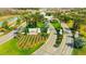 An aerial view of the community entrance with manicured landscaping, palm trees, and a decorative entrance sign at 4576 Garofalo Rd, Wesley Chapel, FL 33543