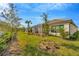 Backyard featuring a screened-in porch and landscaped garden at 4576 Garofalo Rd, Wesley Chapel, FL 33543