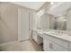 Bathroom with dual sinks, white cabinets, and glass-enclosed shower at 4576 Garofalo Rd, Wesley Chapel, FL 33543