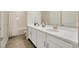 Modern bathroom featuring double sinks, a spacious vanity, and stylish fixtures for a luxurious experience at 4576 Garofalo Rd, Wesley Chapel, FL 33543