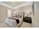 Serene bedroom featuring a tray ceiling, neutral decor, and two bedside tables at 4576 Garofalo Rd, Wesley Chapel, FL 33543