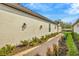 Exterior shot of the home's siding with a brick walkway at 4576 Garofalo Rd, Wesley Chapel, FL 33543