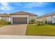 Charming single-story home with a beautifully landscaped front yard and brick driveway at 4576 Garofalo Rd, Wesley Chapel, FL 33543