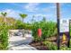 Fireside seating area with a modern fire pit, comfortable chairs, and lush landscaping for outdoor relaxation at 4576 Garofalo Rd, Wesley Chapel, FL 33543