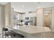 Modern kitchen featuring stainless steel appliances, white cabinets, and a large quartz countertop island at 4576 Garofalo Rd, Wesley Chapel, FL 33543