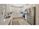 Bright kitchen with white cabinetry and stainless steel appliances, featuring modern fixtures at 4576 Garofalo Rd, Wesley Chapel, FL 33543