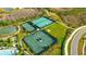 Aerial view of tennis courts and recreational facilities, set among green landscaping and waterways at 4576 Garofalo Rd, Wesley Chapel, FL 33543