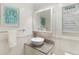 A bright bathroom featuring a stylish vessel sink, granite countertop, and decorative nautical themed art at 505 67Th Ave # 5, St Pete Beach, FL 33706