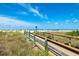 Wooden walkway leading to a beautiful beach with soft sand and clear blue skies in the distance at 505 67Th Ave # 5, St Pete Beach, FL 33706