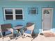 Inviting exterior seating area with wicker chairs, perfect for relaxing near the front door at 505 67Th Ave # 5, St Pete Beach, FL 33706