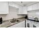 Well-lit kitchen with modern appliances and clean, white cabinetry at 505 67Th Ave # 5, St Pete Beach, FL 33706