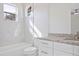 Bright bathroom with white cabinets, granite countertop, and marble tile at 5226 Golf Links Blvd, Zephyrhills, FL 33541