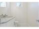 Clean bathroom with granite countertop, white cabinets, and a toilet at 5226 Golf Links Blvd, Zephyrhills, FL 33541