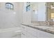 Clean bathroom with marble tile and granite countertop at 5226 Golf Links Blvd, Zephyrhills, FL 33541