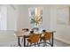 Dining area with a wood table, four chairs, and natural light at 5226 Golf Links Blvd, Zephyrhills, FL 33541