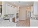 Modern kitchen with white cabinets, stainless steel appliances, and large island at 5226 Golf Links Blvd, Zephyrhills, FL 33541