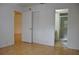 Bedroom with wood floors, closet, and bathroom access at 5265 E Bay Dr # 323, Clearwater, FL 33764