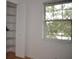 Cozy bedroom with a large window and built-in shelving at 5265 E Bay Dr # 323, Clearwater, FL 33764