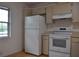 White appliances and cabinets in this galley-style kitchen at 5265 E Bay Dr # 323, Clearwater, FL 33764