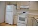 White kitchen appliances and cabinets at 5265 E Bay Dr # 323, Clearwater, FL 33764