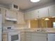 Efficient kitchen with white appliances and ample cabinetry at 5265 E Bay Dr # 323, Clearwater, FL 33764