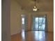 Living room with vaulted ceiling, wood floors, and sliding glass doors at 5265 E Bay Dr # 323, Clearwater, FL 33764