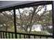 Screened balcony overlooking a peaceful pond and lush trees at 5265 E Bay Dr # 323, Clearwater, FL 33764