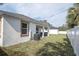 View of the backyard with a patio, well-maintained lawn, and privacy fence, providing a serene outdoor space at 5331 71St N Way, St Petersburg, FL 33709