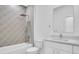 A stylish bathroom featuring a shower-tub combo, a toilet and tiled wall at 5331 71St N Way, St Petersburg, FL 33709