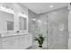 A large bathroom with dual sinks, a soaking tub, and a luxurious glass enclosed shower at 5331 71St N Way, St Petersburg, FL 33709