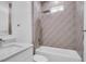 A stylish bathroom featuring a shower-tub combo and tiled wall at 5331 71St N Way, St Petersburg, FL 33709