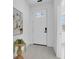 Hallway view featuring a plant on a table and a white door with glass panes, and light wood-look flooring at 5331 71St N Way, St Petersburg, FL 33709